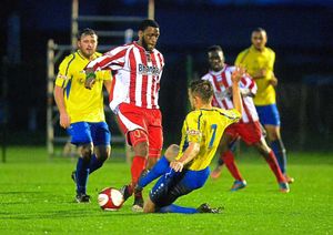 Justin Richards on the end of a tough challenge by Conor Green