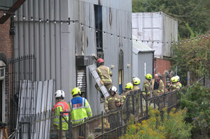 Officers were seen cutting into the side of the building to make accessing the blaze easier. Photo credit: WMFS