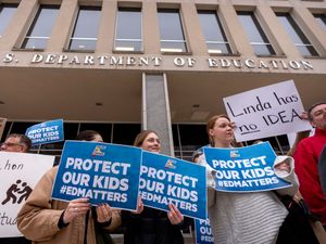 Protestors gather during a demonstration at the headquarters of the Department of Education in Washington