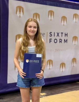Pippa, a Three Spires Sixth Form Year 13, smiling with her results at the Results Day Celebration taking place at St Peter's Collegiate Academy.