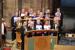 The choir wear Wolves and England scarves at the memorial service