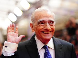 Martin Scorsese smiling and waving