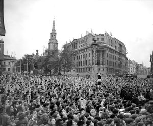 The Coronation Day crowd in Trafalgar Square, some using periscopes to get a glimpse of the Queen's coach as it passes.