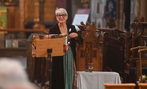 Celebrant Sian Allen pours a glass of red wine for Rose Roberts