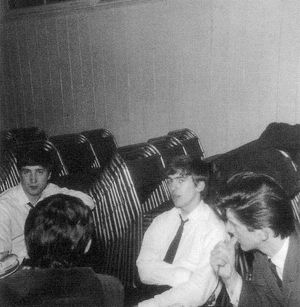 John, George, and Roger – with the Music Hall's chairs stacked up in the background.