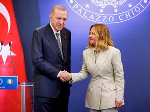 Turkish President Recep Tayyip Erdogan and Italian Premier Giorgia Meloni shaking hands