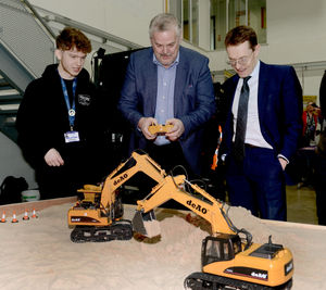Councillor Ian Brookfield learns how control a digger at the launch of Wolverhampton College's plant facility at its Wellington Road campus.