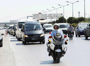 A convoy of four ambulances carrying the bodies of eight Britons shot dead by student Seifeddine Rezgui, arrive at Tunis military airport, ahead of an RAF flight back to Brize Norton in Oxfordshire