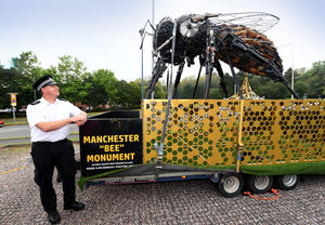 Inspector Richard Jones next to the Anti-Violence Bee monument made from firearms and blades