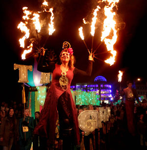 Thousands of people line the streets of Dublin watching the New Year's Eve People's Procession of Light, an atmospheric torch-lit procession illuminating its way through the city