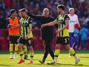 Pep Guardiola speaks with Mateo Kovacic (left) and Ruben Dias