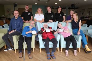 Back : Emir Gibson, Axel Drioli, Jacinth Latta, Owain Llwyd, Catrin Medi, carer Angela Williams, Nia Davies Williams
Seated front : Residents John Carson, Dr John Jones and Kathleen Taylor
