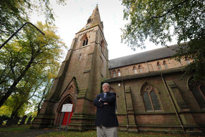 Rev Richard Merrick in the grounds at Holy Trinity Church which have been spruced up