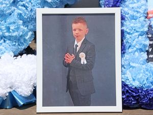 A photo of Charlie Joyce, nine, outside a church ahead of his funeral