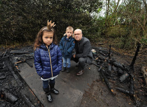 Merridale Primary School headteacher Simon Lane with pupils Essence Johnson and Daniel Dmitriev among the fire damage