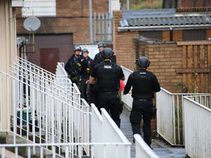 Supporting image for story: PICTURED: Armed police swoop on flat to arrest suspect and seize weapons