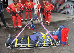 Firefighters training with an overweight mannequin