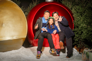  Photo caption: Young girl and her family within the snow at Santa’s Winter Wonderland at the SnowDome. 
