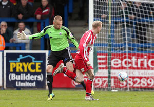 James Walshaw of Altrincham takes the ball past Ryan Young of AFC Telford United before scoring to make it 3-1