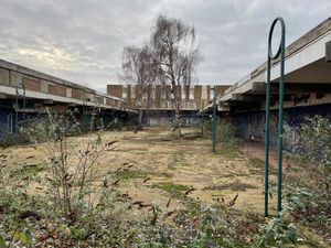 The former shopping precinct is overgrown