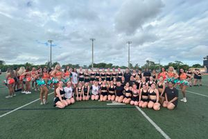 The students and their dance colleagues pose with cheerleaders from the Miami Dophins