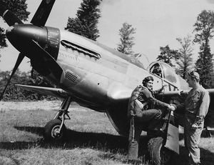 Crew chief Wayne with a Lieutenant Rakow who is climbing into a Mustang fighter called Fay's Falcon Mk II – possibly named after Wayne's Shropshire bride.