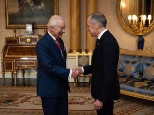 The King shakes hands with Mark Carney, the Prime Minister of Canada, at Buckingham Palace