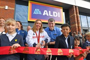  Aldi  opened a brand-new store on Oldbury Green Retail Park this morning . Paralympic gold medallist Megan Richter cut the ribbon on the store.Here she is pictured with store manager Liam Jones and schoolchildren from the area.