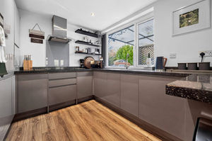 A sleek modern kitchen designed for both practicality and sociable living
