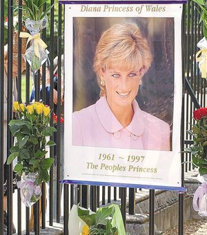 August 31, 2003: A poster and flowers with cards tied on the gates of Kensington Palace, London, on the sixth aniversary of the death of Princess Diana who died in a car crash in 1997.