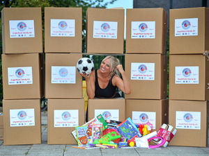 Supporting image for story: Group is on ball with family kits of games, arts and crafts