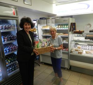 Sue receives her luxury hamper from the leagues volunteer coordinator Christine Foster
