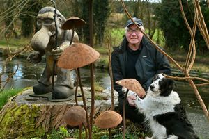 John Massey in his garden with his dog Willow