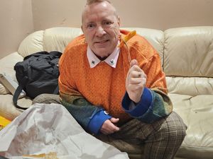 Supporting image for story: 'The chips are the same colour as my jumper!' Johnny Rotten spotted in Bilston tucking into Major's orange chips ahead of sold-out gig