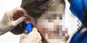 Torturous or fine? A piercing gun being used on a child's ear