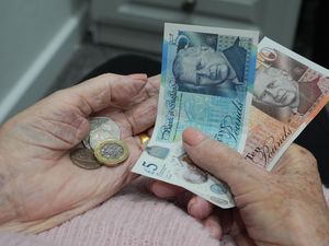 A pensioner holding banknotes