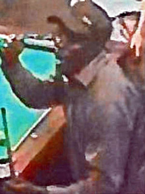 Another image of the suspect in the cap
