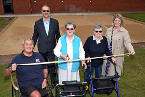 Vicky Evans of Newport U3A Petanque group cutting the ribbon to officially open the three new pistes at Lilleshall National Sports Centre watched by Andrew Dunham of Mcphillips (back left) and Katherine Bright of WSP