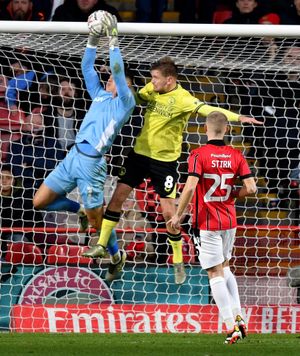 Tommy Simkin gets to the ball.