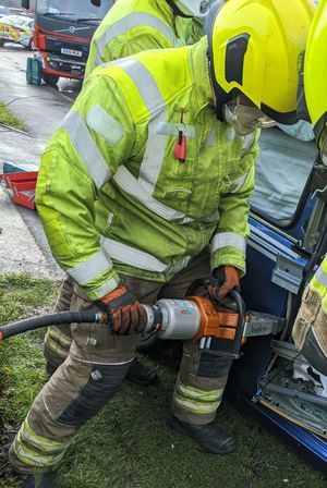Firefighters working to free the man from the vehicle. Photo: Aldridge Fire Station