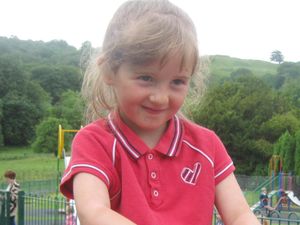 April Jones smiling and wearing a red shirt