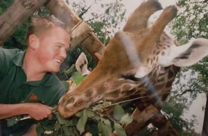 Anthony Hall with Sophie the Giraffe at Dudley Zoo