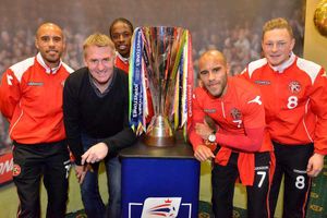 Dean Smith, with left to right: James Chambers, Romaine Sawyers, Adam Chambers, Sam Mantom, and the coveted trophy