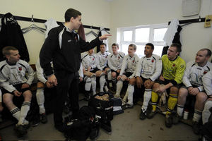 Chris Kamara (third right) listens to manager David Jones (centre) during the Spa Mid Wales League match at Maes y Dre Recreation Ground, Welshpool