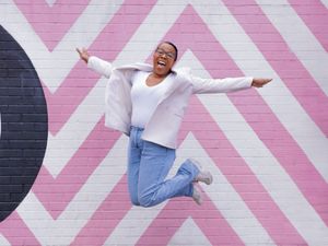 Danielle jumping for joy at a photo shoot.