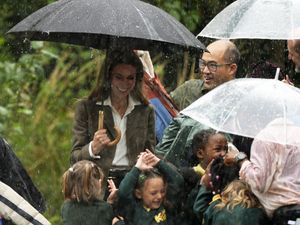 Supporting image for story: Kate debuts blonde look as she leads schoolchildren out of rainstorm