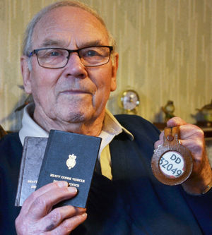 Driver Derek with his licences and driver's badge.
