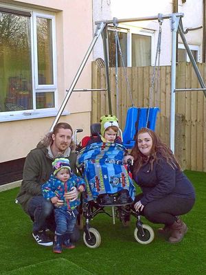Charlie Gibney with his parents Andrew and Jess