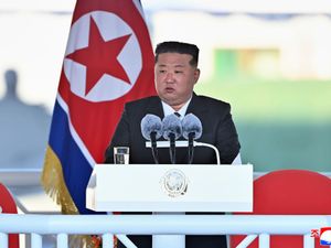 Kim Jong Un speaks during a launching ceremony of a new naval destroyer at a western port in Nampo, North Korea