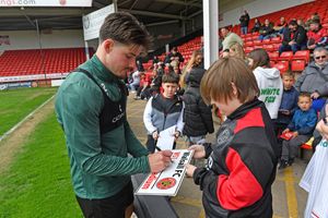Jamie Jellis gives out his autograph to a young fan.